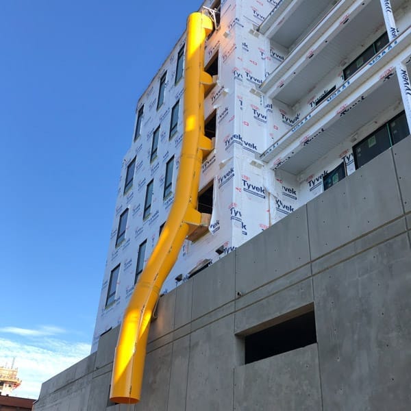 Superchute debris chute curving around a podium.