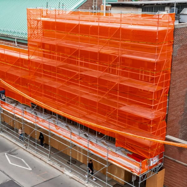 Scafnet orange mesh installed on an entire building.